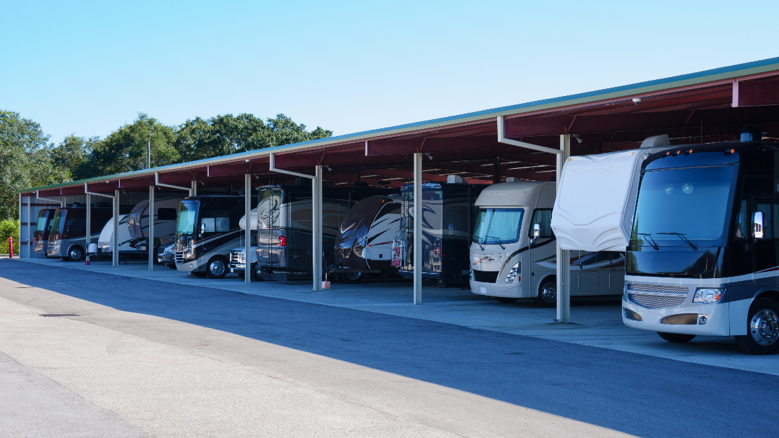 A line of RVs in storage.