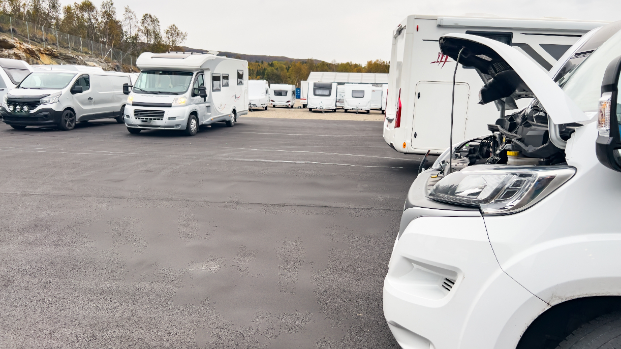 An RV dealership with several motorhomes visible.